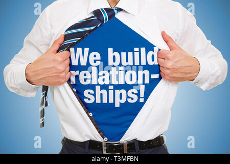 Man carries slogan We build relationships! on t-shirt under business shirt as a concept for successful networks Stock Photo