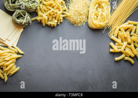 Different types of pasta from durum wheat varieties for cooking Mediterranean dishes. Top view, space for text. Stock Photo