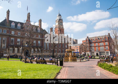 People enjoying spring sunshine in Town Hall Square in the centre of Leicester Stock Photo