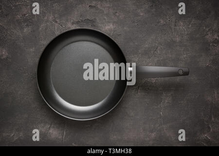 Empty Frying Pan Black on Dark Stone Surface. Culinary Background. Stock Photo