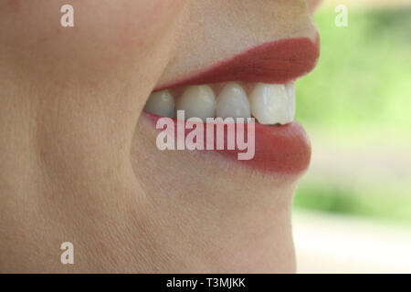 Red lips and white teeth of a beautiful woman Stock Photo