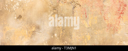 Painted wall. Beige yellow color, painted and faded wall texture grunge background Stock Photo
