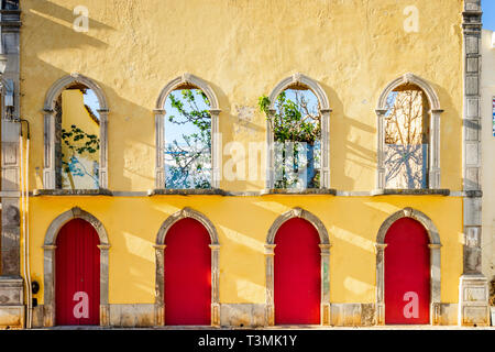 Yellow façade of empty traditional house in Tavira, Algarve, Portugal Stock Photo