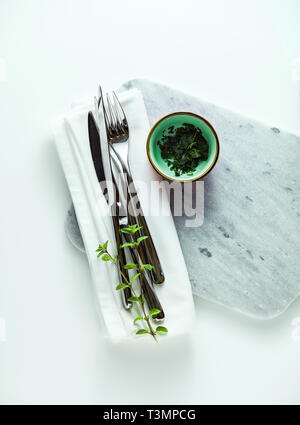 empty marble cutting board on a white table Stock Photo