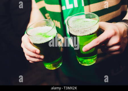 Barman hands pouring a lager beer in a glass Stock Photo