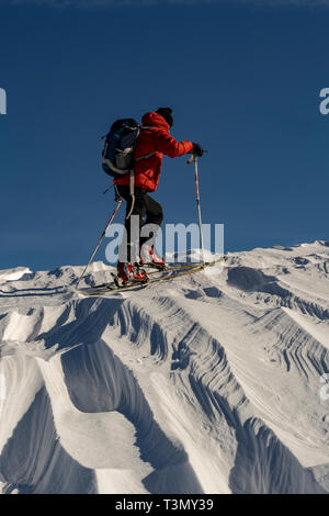 Male backcountry skier ascends on the slopes of Tarcu Summit, Romania Stock Photo