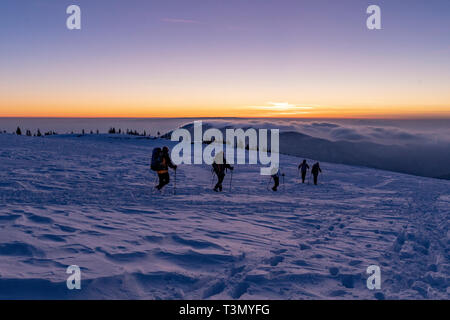 Climbers descending at sunset Stock Photo
