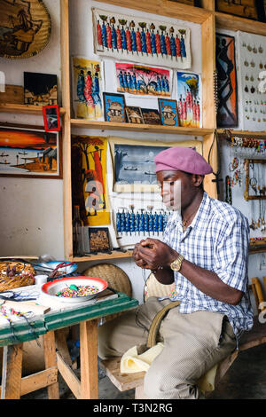 Artist in his handcraft and souvenir shop in Mbeya, Tanzania.   ---   Kunsthandwerker in seinem Shop in Mbeya, Tansania Stock Photo