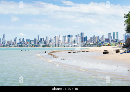 Local people and tourists at Praia do Bessa beach, Joao Pessoa PB, Brazil. Beachfront buildings on background. Stock Photo