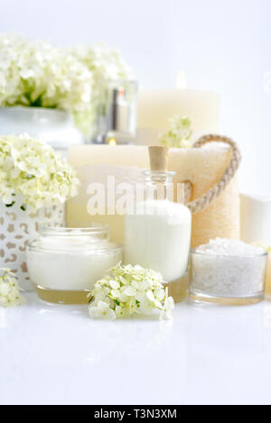 Spa composition with candles, cream, salt and flowers of hydrangea on a white background Stock Photo