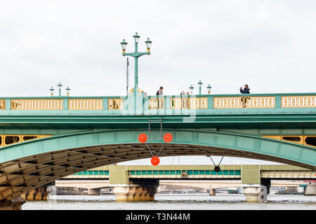 Tourists taking photographs on Southwark Bridge, Bankside, London, UK Stock Photo