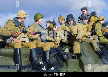 SAINT-PETERSBURG, RUSSIA - FEBRUARY 17, 2019: Soviet soldiers on the armor of an armored personnel carrier. Fragment of the military-historical festiv Stock Photo
