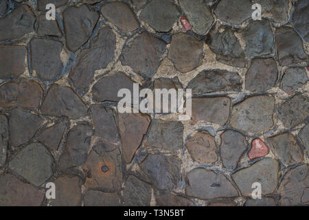 Background of natural stones. The road from the cobblestone. Stock Photo