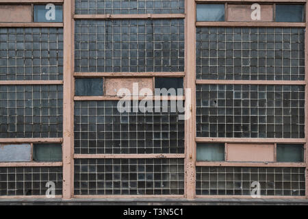 The old shabby wall of glass blocks Stock Photo