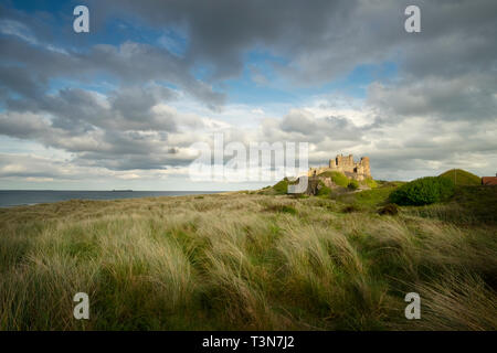 Bamburgh castle and Farne Islands on the horizon, Northumberland, England, UK  (May 2017) Stock Photo