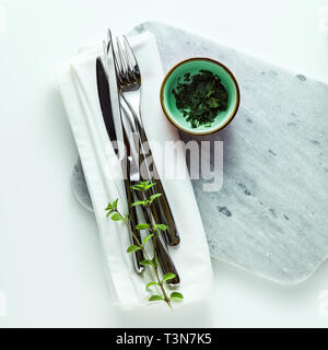 empty marble cutting board on a white table Stock Photo