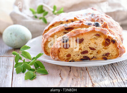 Easter Bread (Osterbrot in German). Close-up on traditional fruty bread on rustic wood with fresh leaves and quail eggs. Traditional German dessert fo Stock Photo