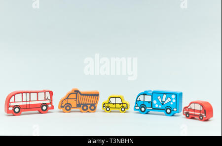 wooden retro typewriter toy on a light background. group of cars with empty space. close-up. educational toys for children. Stock Photo