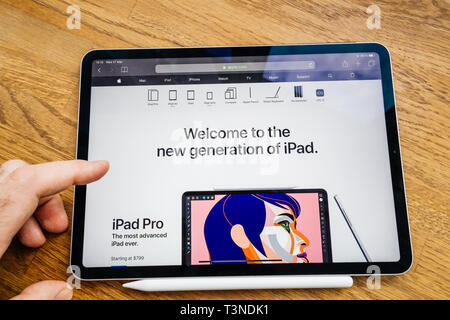 Paris, France Mar 27, 2019: Man hand POV looking at the new iPad Pro featuring Apple Computers website with welcome to new generation of iPad with Pro model advertised Stock Photo