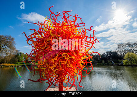 Kew Gardens, London, UK. 11th Apr 2019. Summer Sun - Chihuly: Reflections on nature at Kew Gardens - Dale Chihuly exhibits his luminous glass artworks, featuring pieces never seen before in the UK. Chihuly's sculptures transform the Gardens and glasshouses into a contemporary outdoor gallery space. Credit: Guy Bell/Alamy Live News Stock Photo