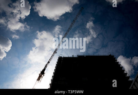 Hannover, Germany. 11th Apr, 2019. Clouds move over a construction crane and a building under construction. An IntercityHotel with 220 hotel rooms on 15 floors is being built near the main railway station. Credit: Moritz Frankenberg/dpa/Alamy Live News Stock Photo