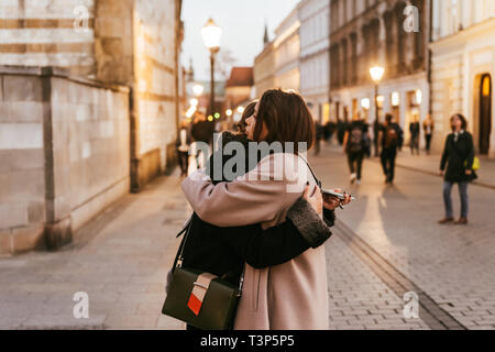 Close-up photo of two emotional woman friends hugging each other Stock Photo