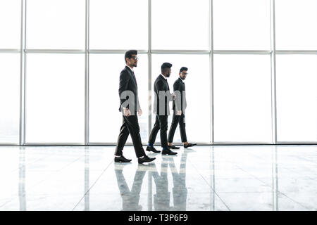 Confident business partners walking down in office building and talking about new project. Stock Photo