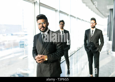 Portrait of three happy success handsome business man walk and talk. Teamwork friendship. Stock Photo