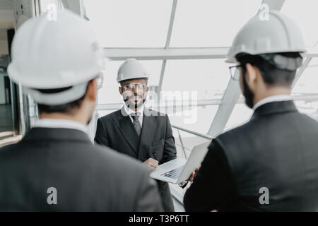 businessman and architects discussing the sketches of the new project Stock Photo