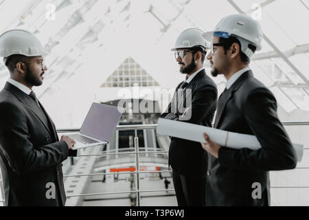 businessman and architects discussing the sketches of the new project Stock Photo