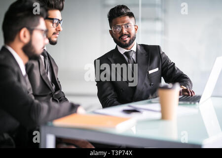 Cheerful office workers discussing their project over cup of tea Stock Photo