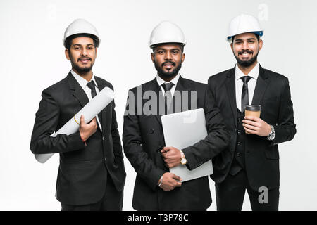 Three indian businessmen architect in the construction helmets standing isolated on white background Stock Photo