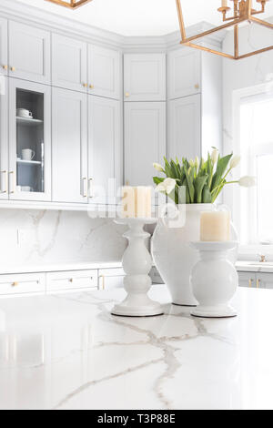 A luxurious white and blue kitchen with gold hardware, Bosch and