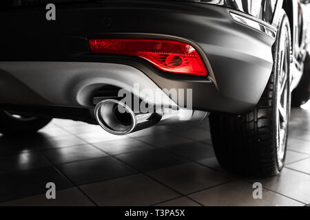 car exhaust pipe. Exhaust pipe of a luxury car. details of stylish car interior, leather interior. Close up Stock Photo