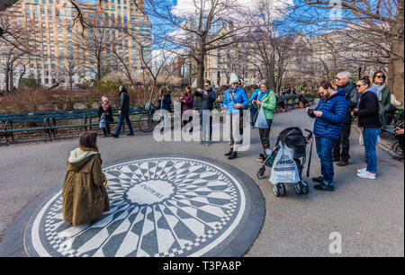 NEW YORK CITY- MARCH 23, 2018 : Tourist at the Strawberry Fields John Lennon memorial one of the main Manhattan Landmarks Stock Photo