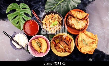 Assorted Chinese food set. Chinese noodles, fried rice, peking duck, dim sum, spring rolls. Famous Chinese cuisine dishes on table. Chinese restaurant Stock Photo