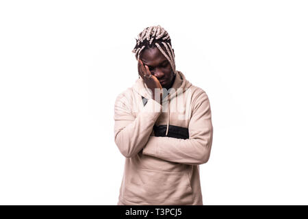 Young afro american man looking sad and depressed posing emotional in sadness face expression isolated on white background Stock Photo