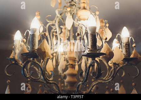 luxury expensive chandelier hanging under ceiling in palace. Stock Photo