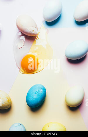 Dyeing eggs for Easter holidays, coloring with different   color and tonality using food colorant over a gray concrete background Stock Photo