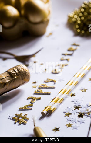 Luxury easter celebration concept, top view of golden items used to celebrate festivity  on a white background  with an hashtag celebrating the happy  Stock Photo