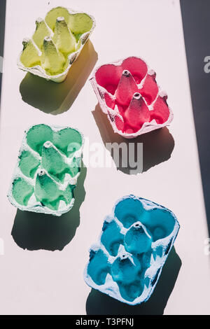 Colored eggs container, easter concept, hard natural direct light Stock Photo