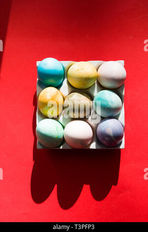 Colored eggs container, easter concept, hard natural direct light Stock Photo