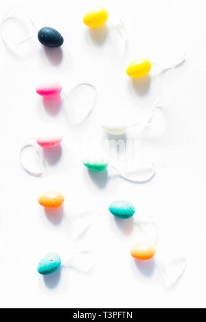 Colorful small eggs on a white background arranged to form the letter r, holiday easter concept Stock Photo