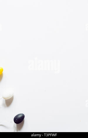 Colorful small eggs on a white background, holiday easter concept Stock Photo