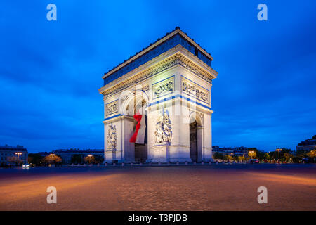 Paris street at night with the Arc de Triomphe in Paris, France. Stock Photo