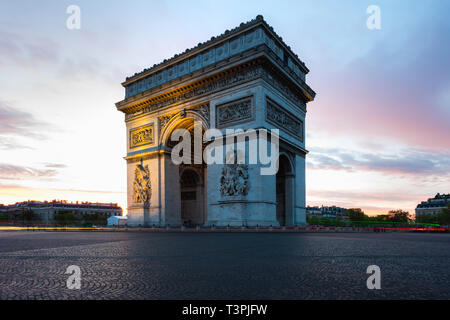 Paris street during sunrise with the Arc de Triomphe in Paris, France. Stock Photo