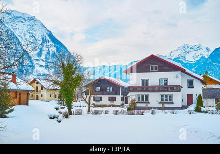 The cozy wooden houses in snowy valley among the great Dachstein Alps, Obertraun, Salzkammergut, Austria. Stock Photo