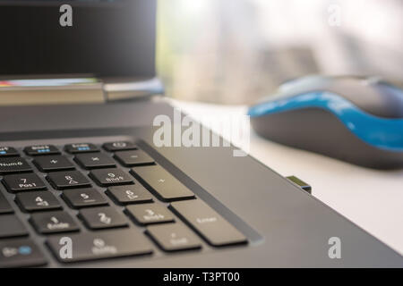 Number pad on a notebook with wireless mouse Stock Photo