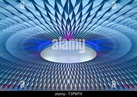 A GLOWING BLUE LIT ORNAMENTAL CEILING CENTREPIECE WITH ARTISTIC RADIAL PATTERN AND GEOMETRIC TEXTURE Stock Photo
