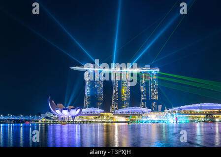 SINGAPORE - MARCH 24, 2019: Spectra - A Light and Water Show at Marina Bay Sands and the event Plaza is a free daily 15 minute show. Stock Photo